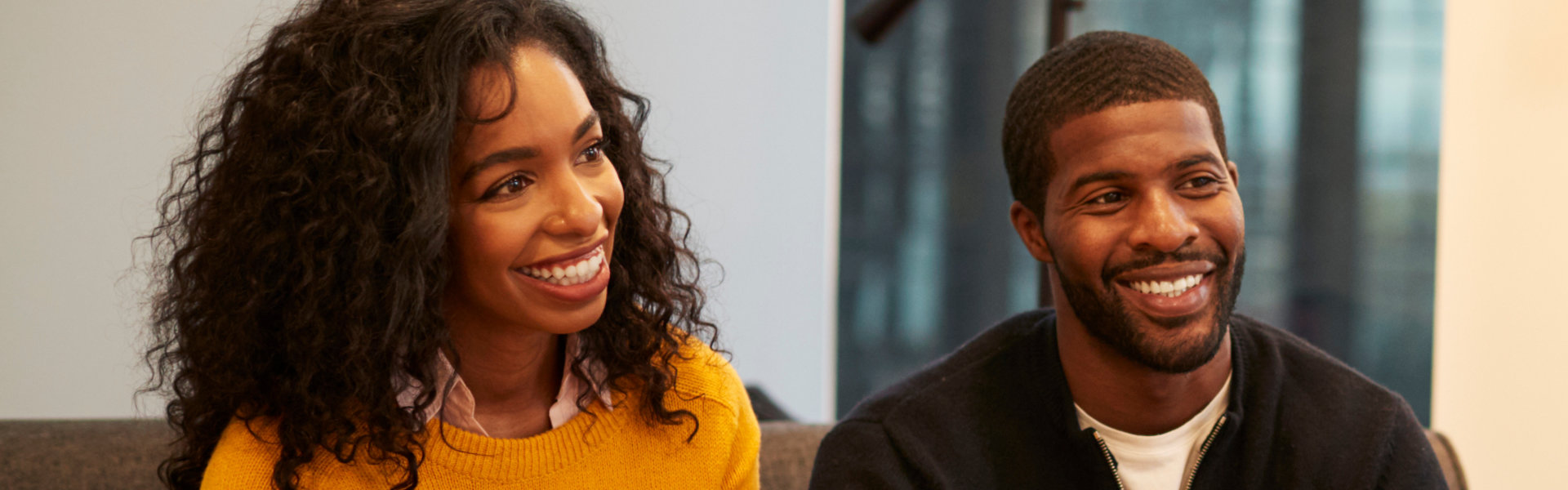 Woman Sitting On Couch Meeting With Male Relationship Counselor In Office